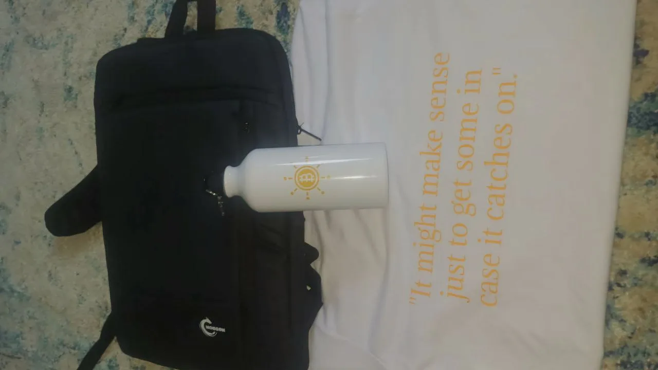 Summer of Bitcoin swag items including t-shirt, stainless steel bottle, and backpack
